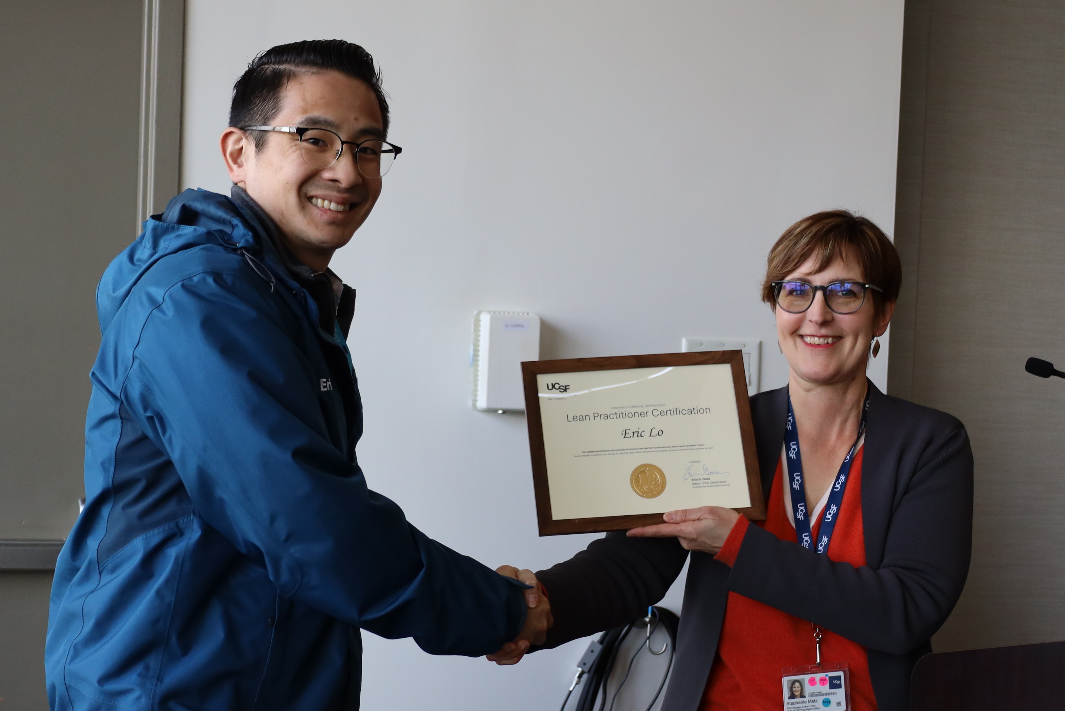 Eric Lo recieving his Lean Practitioner Certificate from Stephanie Metz